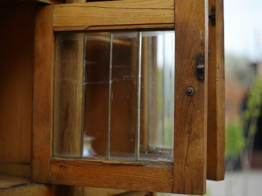 Antique wood cabinet with glass-paned door